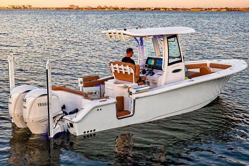 Slide: The Image of 2024 Sea Hunt Ultra 265 SE boat on calm water at sunset. - 44