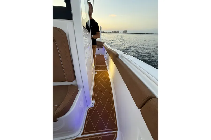 Slide: The Image of 2024 Sea Hunt Ultra 265 SE boat interior with sunset view on the water. - 53