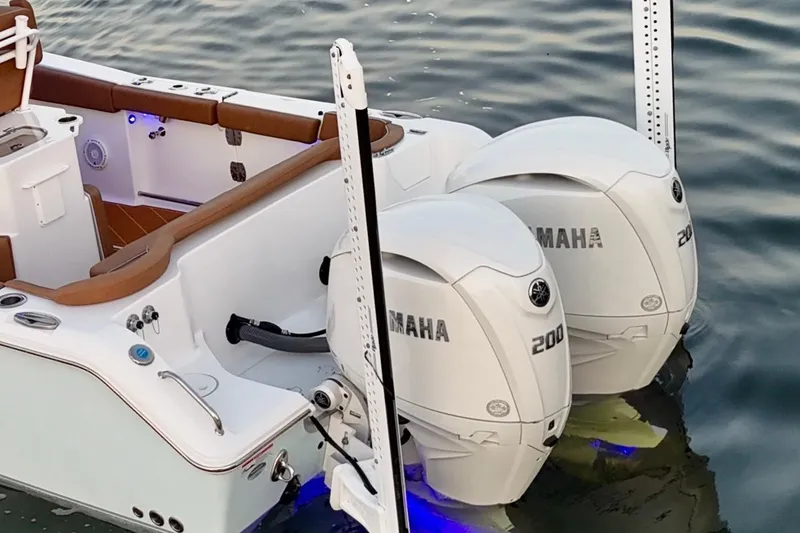 Slide: The Image of 2024 Sea Hunt Ultra 265 SE boat with dual Yamaha 200 engines on water. - 55