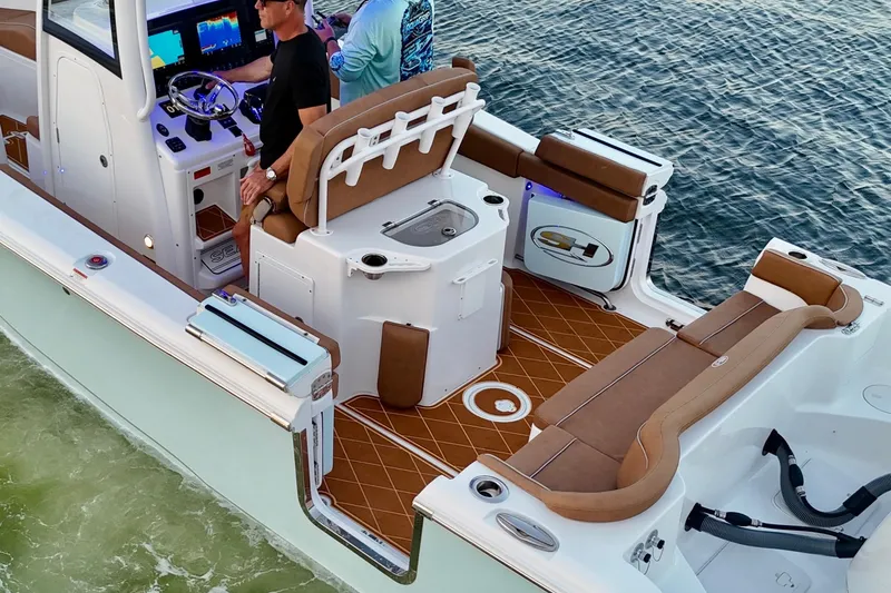 Slide: The Image of 2024 Sea Hunt Ultra 265 SE boat interior with modern controls and seating on water. - 56