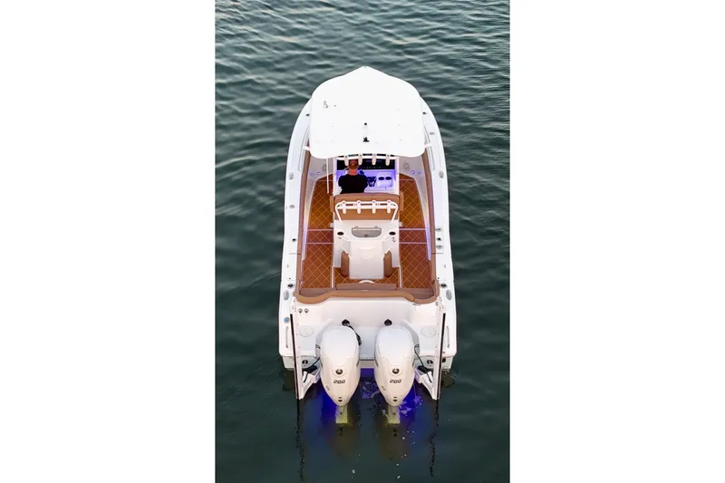 Slide: The Image of 2024 Sea Hunt Ultra 265 SE boat on water, aerial view, dual engines. - 59