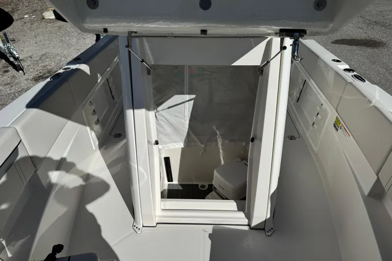 Slide: The Image of 2026 Sailfish 252 CC boat interior with open hatch and visible storage area. - 10