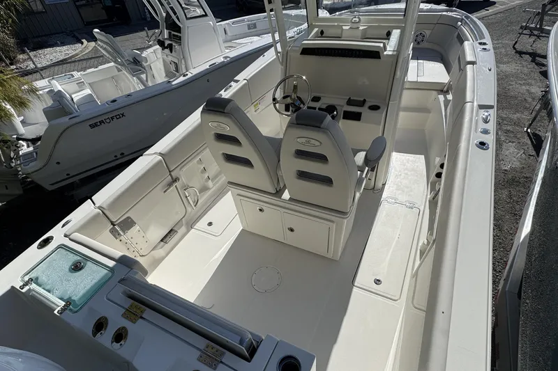 Slide: The Image of 2026 Sailfish 252 CC boat interior with dual seats and steering console. - 15