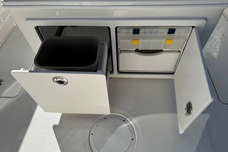 Slide: The Image of Storage compartments on 2026 Sailfish 252 CC boat deck, featuring organized utility space. - 16