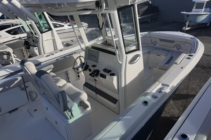 Slide: The Image of 2026 Sailfish 252 CC boat interior with helm, seating, and navigation equipment. - 5