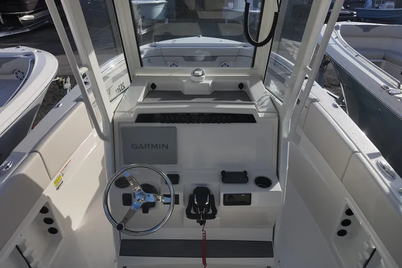 Slide: The Image of 2026 Sailfish 252 CC boat cockpit with Garmin navigation system and steering wheel. - 6
