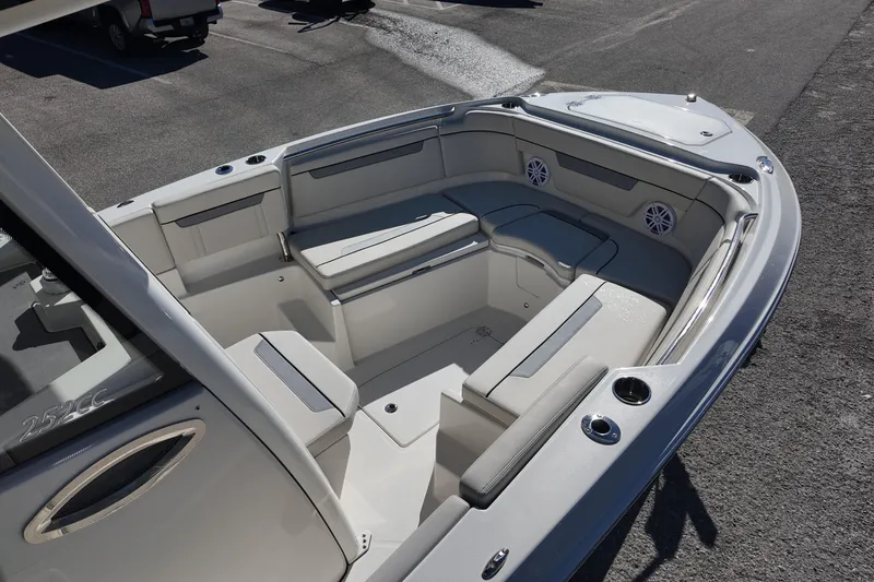Slide: The Image of 2026 Sailfish 252 CC boat interior with cushioned seating and cup holders. - 7