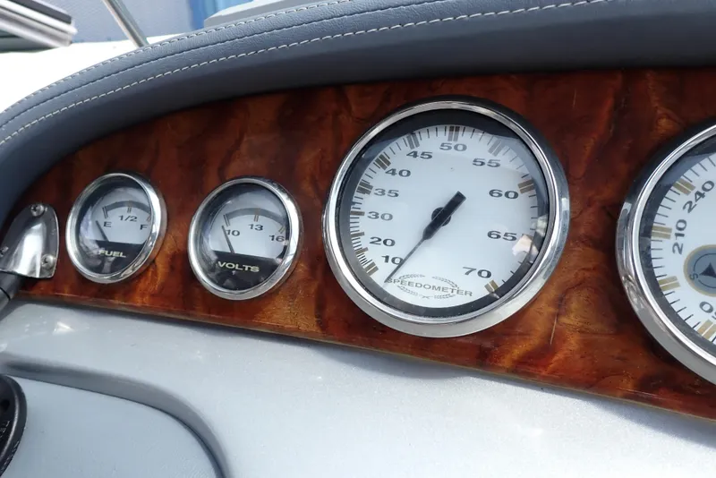 Slide: The Image of Dashboard gauges of a 2002 Cobalt 240 boat, featuring speedometer, fuel, and volt meters. - 12