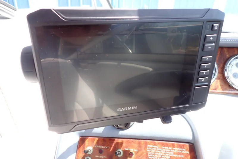 Slide: The Image of Garmin marine GPS device on 2002 Cobalt 240 boat dashboard. - 16