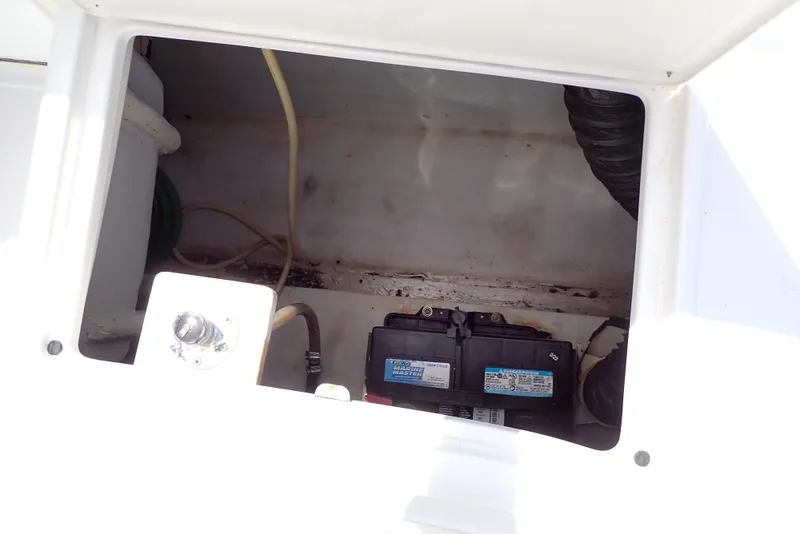 Slide: The Image of Battery compartment of a 2002 Cobalt 240 boat, showing wiring and components. - 35