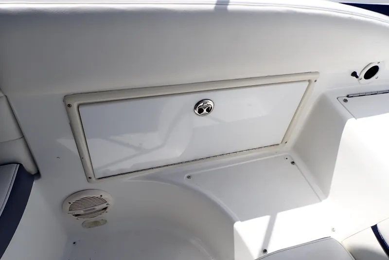 Slide: The Image of 2002 Cobalt 240 boat interior storage compartment with speaker. - 36