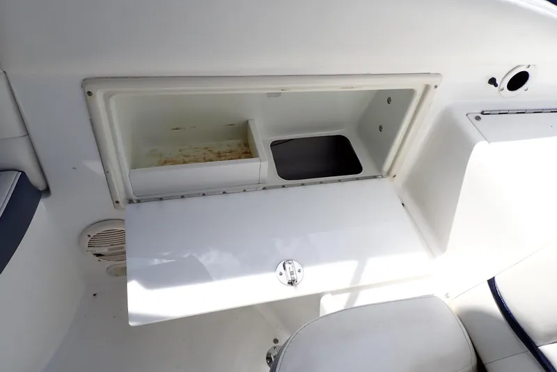 Slide: The Image of Storage compartment on a 2002 Cobalt 240 boat, featuring a white interior and open lid. - 37