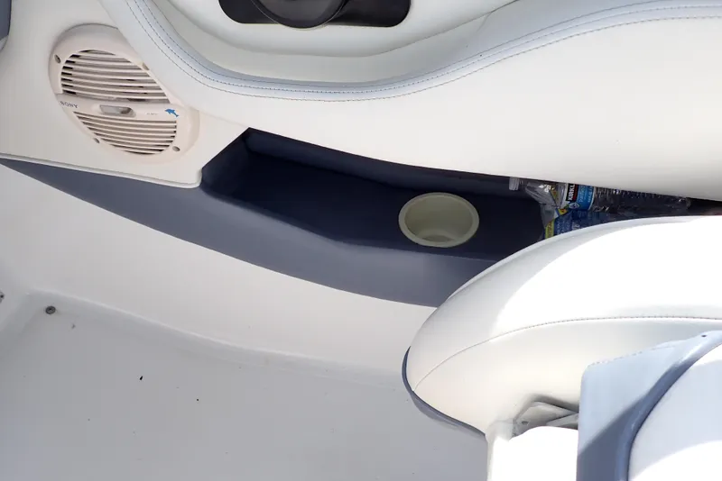 Slide: The Image of Interior of a 2002 Cobalt 240 boat showing speaker and cup holder. - 47