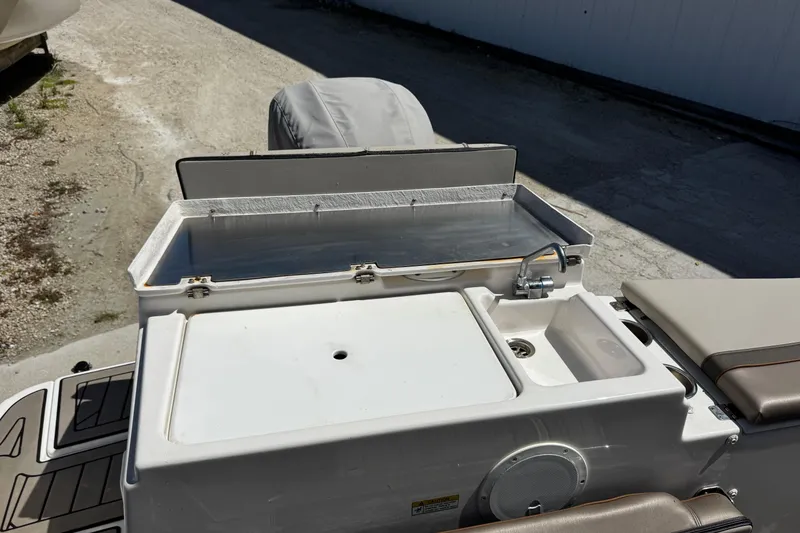 Slide: The Image of 2022 Cutwater C-248 Coupe boat with open storage compartment and sink on deck. - 11