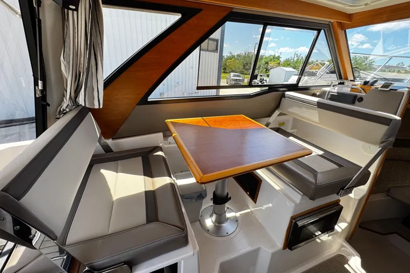 Slide: The Image of Interior of 2022 Cutwater C-248 Coupe with seating and wooden table. - 12