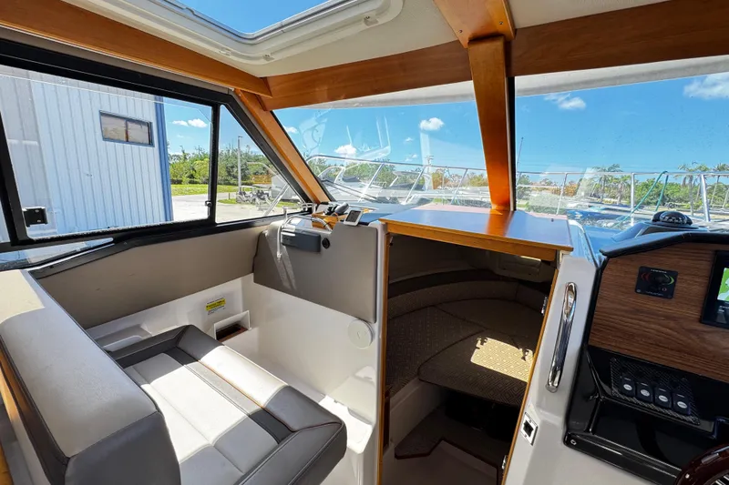 Slide: The Image of Interior view of 2022 Cutwater C-248 Coupe boat, featuring seating and cabin entrance. - 13
