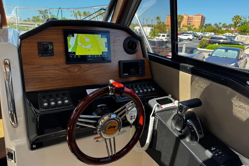 Slide: The Image of Helm of 2022 Cutwater C-248 Coupe with navigation display and controls. - 16