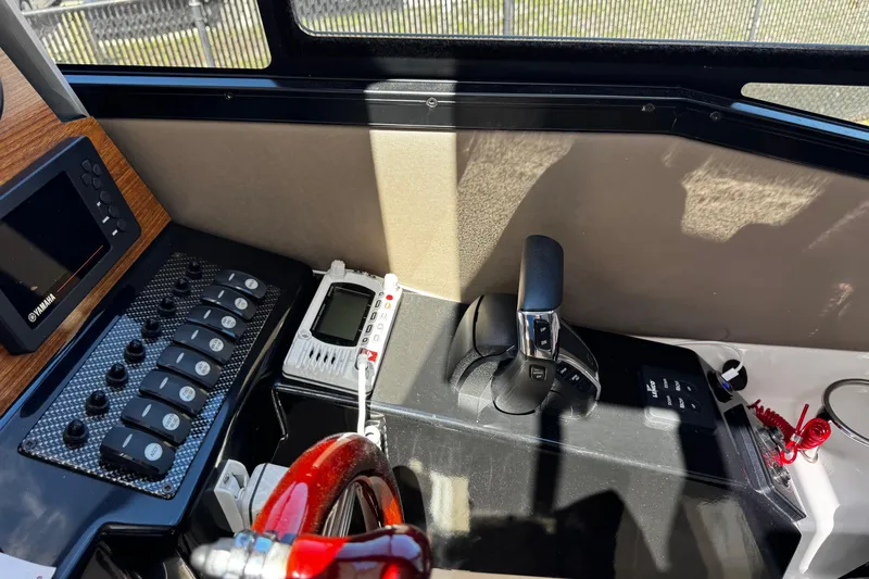 Slide: The Image of 2022 Cutwater C-248 Coupe helm with controls, Yamaha display, and communication device. - 18