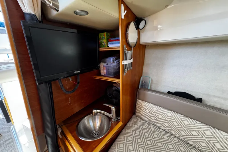 Slide: The Image of 2022 Cutwater C-248 Coupe interior with TV, sink, and storage shelves. - 20