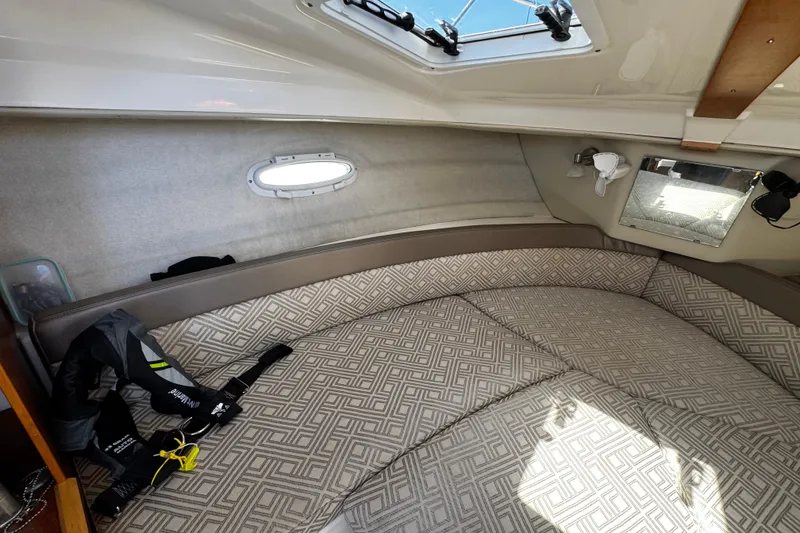 Slide: The Image of Interior cabin of 2022 Cutwater C-248 Coupe with patterned cushions and life jacket. - 21