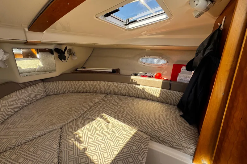 Slide: The Image of 2022 Cutwater C-248 Coupe cabin interior with patterned cushions and natural light. - 22