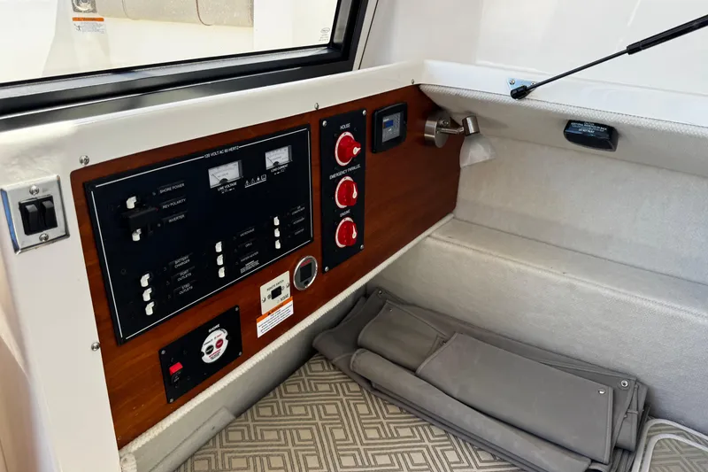 Slide: The Image of 2022 Cutwater C-248 Coupe interior control panel with switches and gauges. - 26