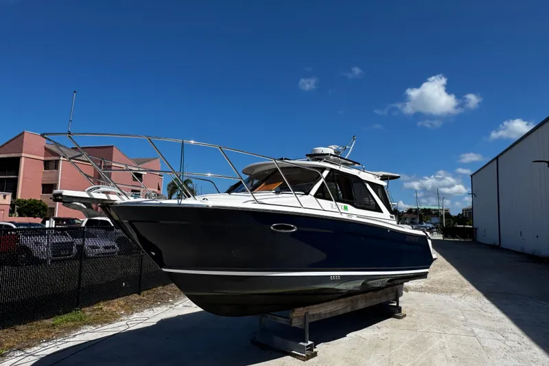 Slide: The Image of 2022 Cutwater C-248 Coupe boat on display outdoors under clear blue sky. - 6