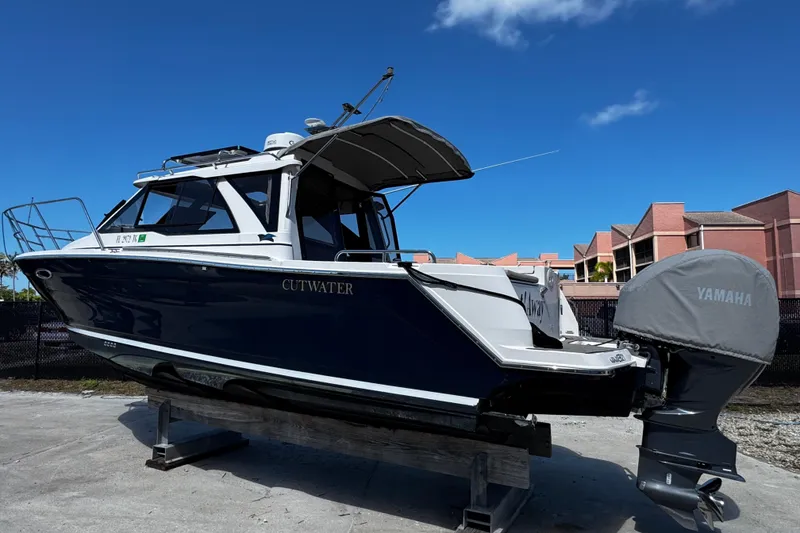 Slide: The Image of 2022 Cutwater C-248 Coupe boat with Yamaha engine, displayed outdoors under clear blue sky. - 7