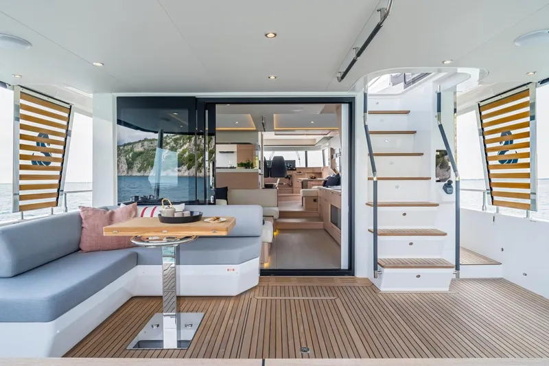 Slide: The Image of Luxurious interior of 2022 Beneteau Grand Trawler 62 yacht with elegant seating and wooden flooring. - 2