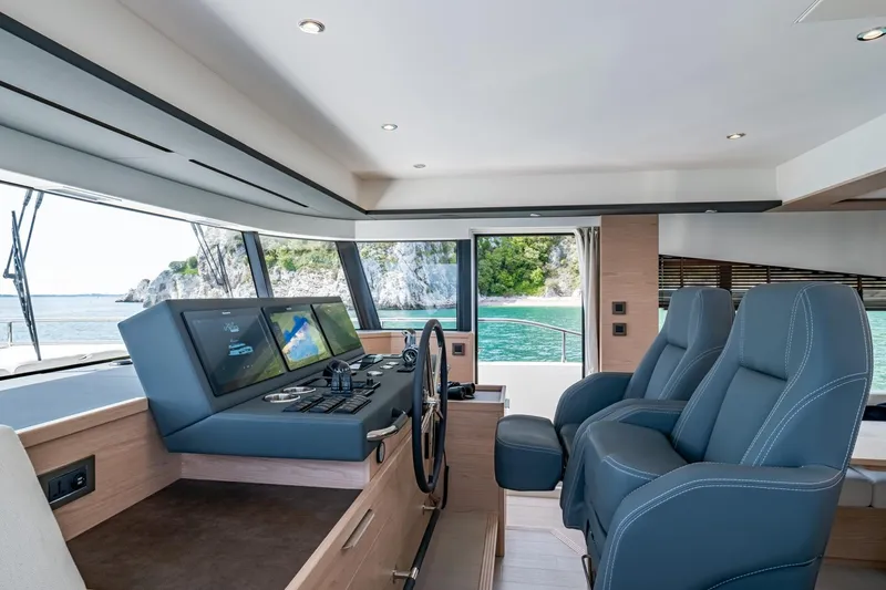 Slide: The Image of Luxurious interior of 2022 Beneteau Grand Trawler 62 with modern navigation system and plush seating. - 3