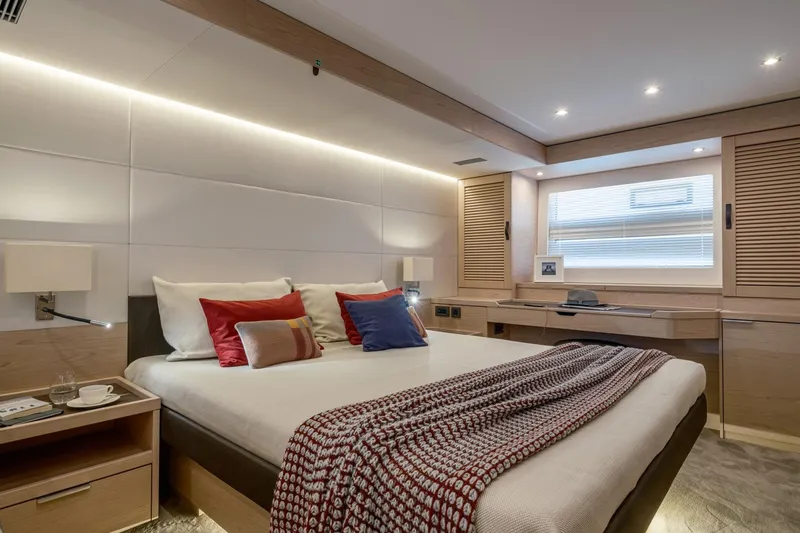 Slide: The Image of Luxurious bedroom interior of 2022 Beneteau Grand Trawler 62 yacht, featuring modern design and cozy decor. - 5