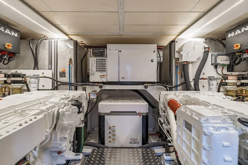 Slide: The Image of Engine room of 2022 Beneteau Grand Trawler 62 with MAN engines and Cummins generator. - 6