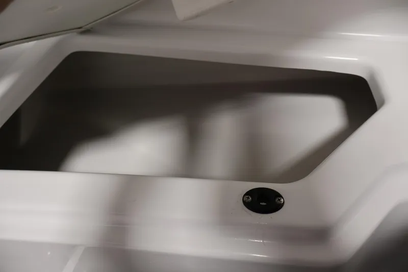 Slide: The Image of Storage compartment of 2021 Scarab 215 ID boat, featuring sleek white interior design. - 14