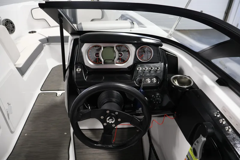 Slide: The Image of 2021 Scarab 215 ID boat dashboard with steering wheel and control panel. - 18