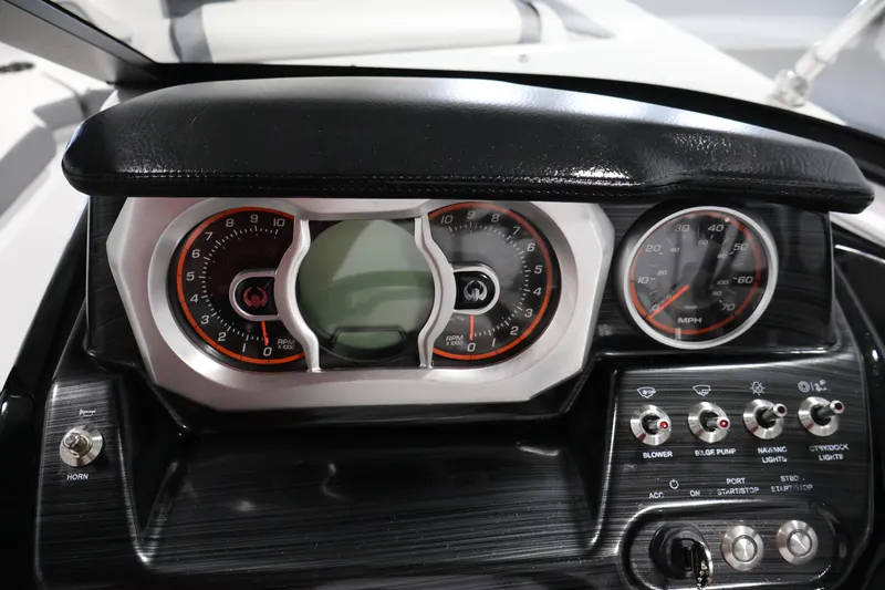 Slide: The Image of Dashboard of a 2021 Scarab 215 ID boat with gauges and controls. - 20