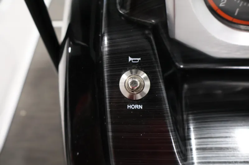 Slide: The Image of Horn button on 2021 Scarab 215 ID dashboard, featuring sleek black design. - 21