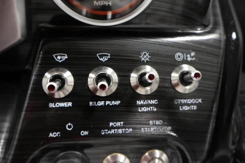 Slide: The Image of Control panel of 2021 Scarab 215 ID boat with switches for blower, bilge pump, and lights. - 22