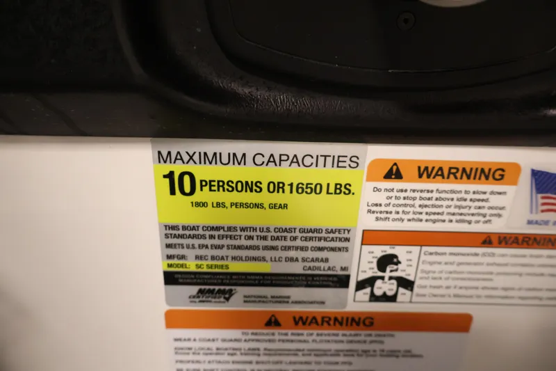 Slide: The Image of Maximum capacity warning label on 2021 Scarab 215 ID boat, 10 persons or 1650 lbs. - 24