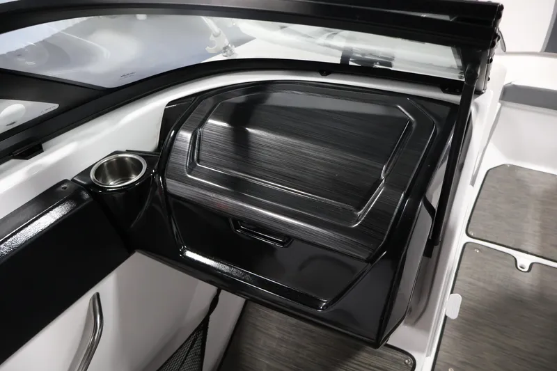 Slide: The Image of 2021 Scarab 215 ID boat interior with sleek black dashboard and cup holder. - 27