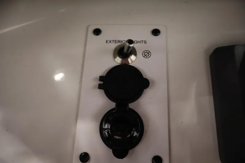 Slide: The Image of Exterior light switch panel on 2021 Scarab 215 ID boat. - 30