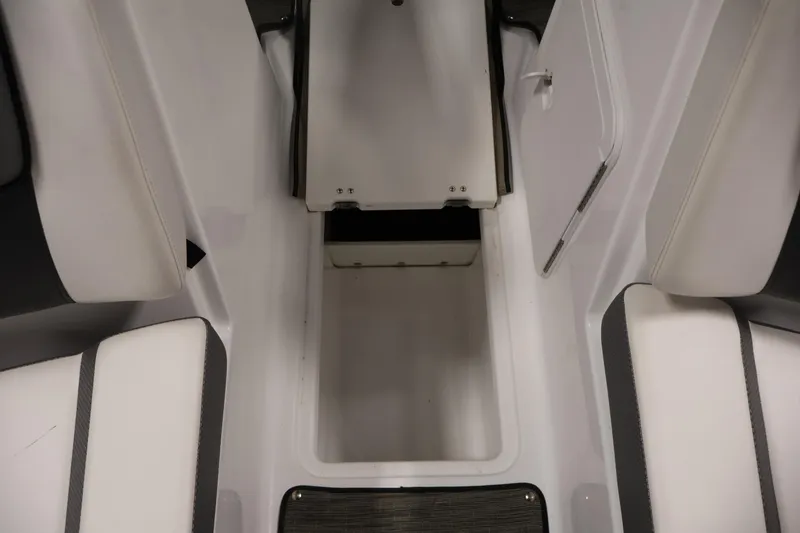Slide: The Image of Interior view of 2021 Scarab 215 ID boat, featuring white seating and storage compartment. - 33