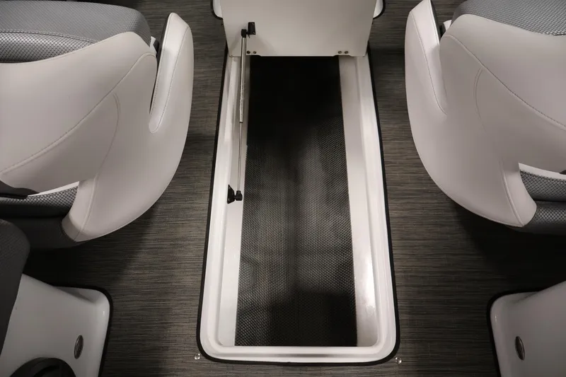 Slide: The Image of 2021 Scarab 215 ID boat interior storage compartment between seats. - 34