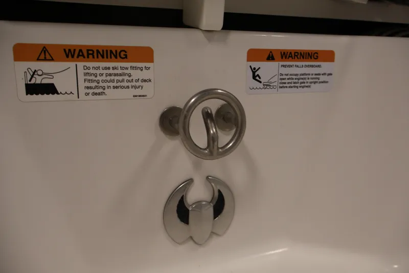 Slide: The Image of Warning labels on 2021 Scarab 215 ID boat, cautioning against improper use. - 42