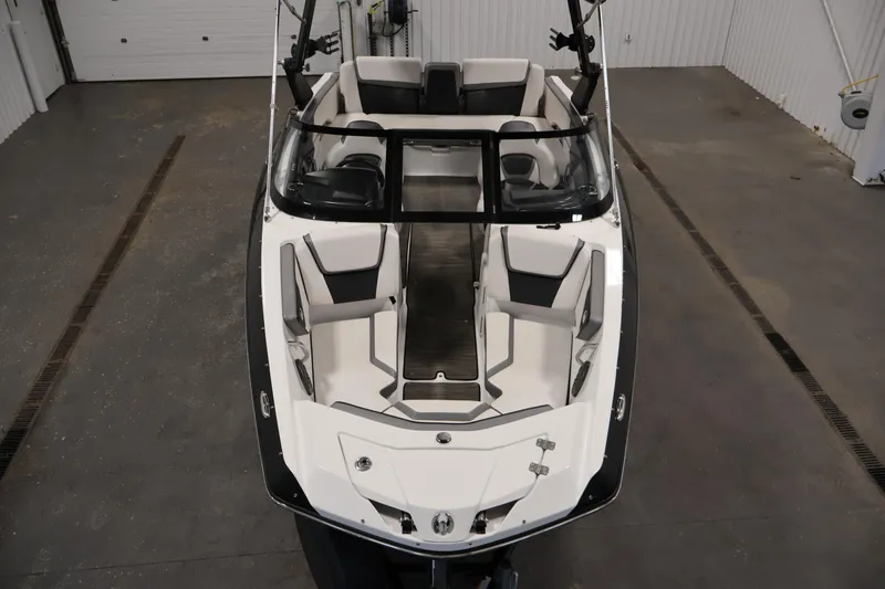 Slide: The Image of 2021 Scarab 215 ID boat interior, featuring sleek seating and modern design in a showroom. - 8