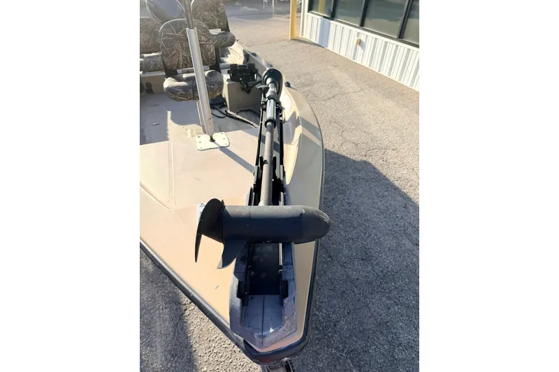 Slide: The Image of 2006 HIGH TIDE 15 boat with trolling motor on deck, parked outdoors. - 11