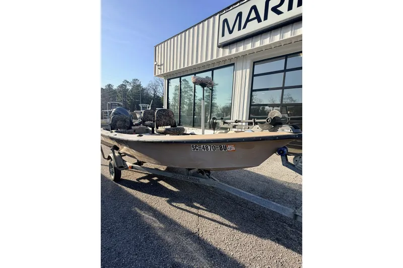 Slide: The Image of 2006 HIGH TIDE 15 boat on trailer outside marine shop. - 13