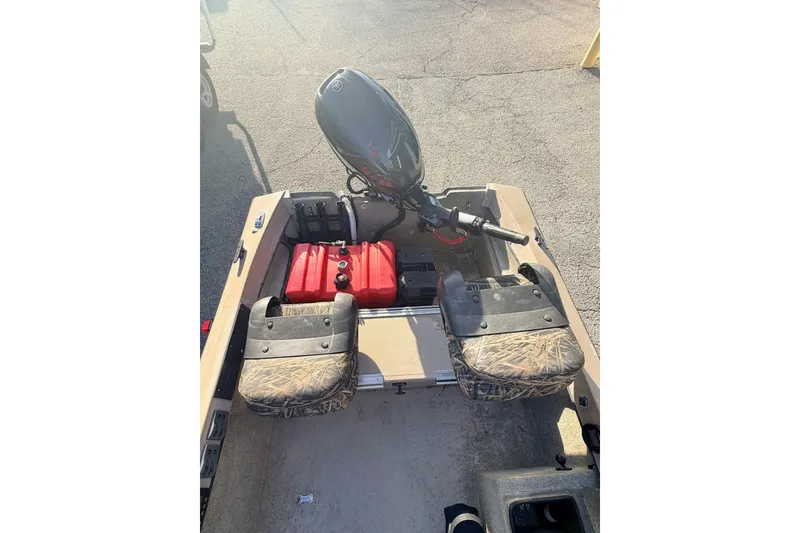 Slide: The Image of 2006 HIGH TIDE 15 boat interior with motor and camouflage seats. - 14
