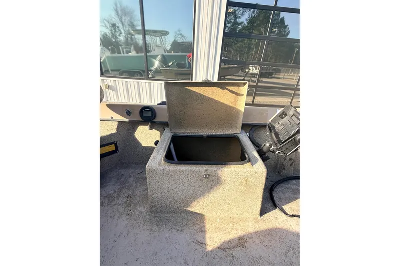 Slide: The Image of Open storage compartment on a 2006 HIGH TIDE 15 boat, with visible equipment nearby. - 15