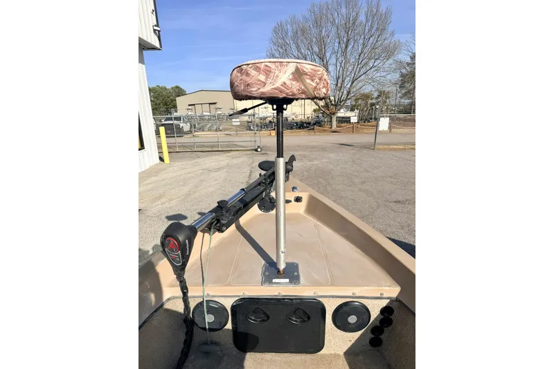Slide: The Image of 2006 HIGH TIDE 15 boat with camo seat and trolling motor in a parking lot. - 4