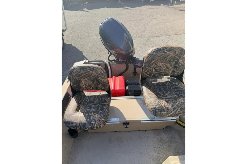 Slide: The Image of 2006 HIGH TIDE 15 boat with camouflage seats and outboard motor. - 7